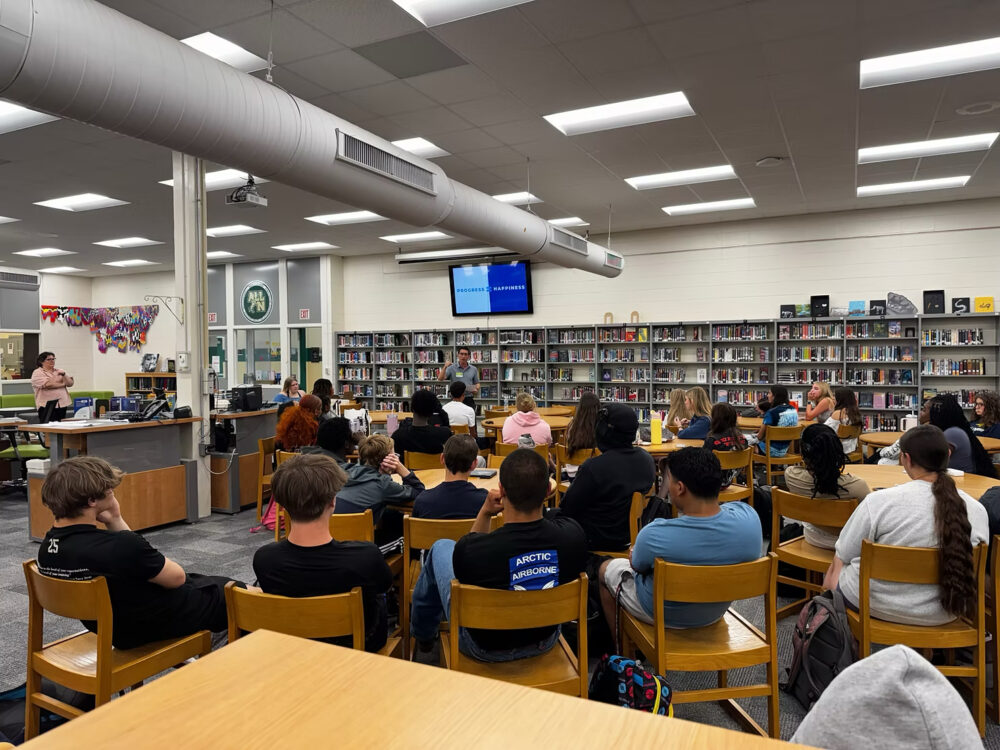 bold companies owner talking to avid students