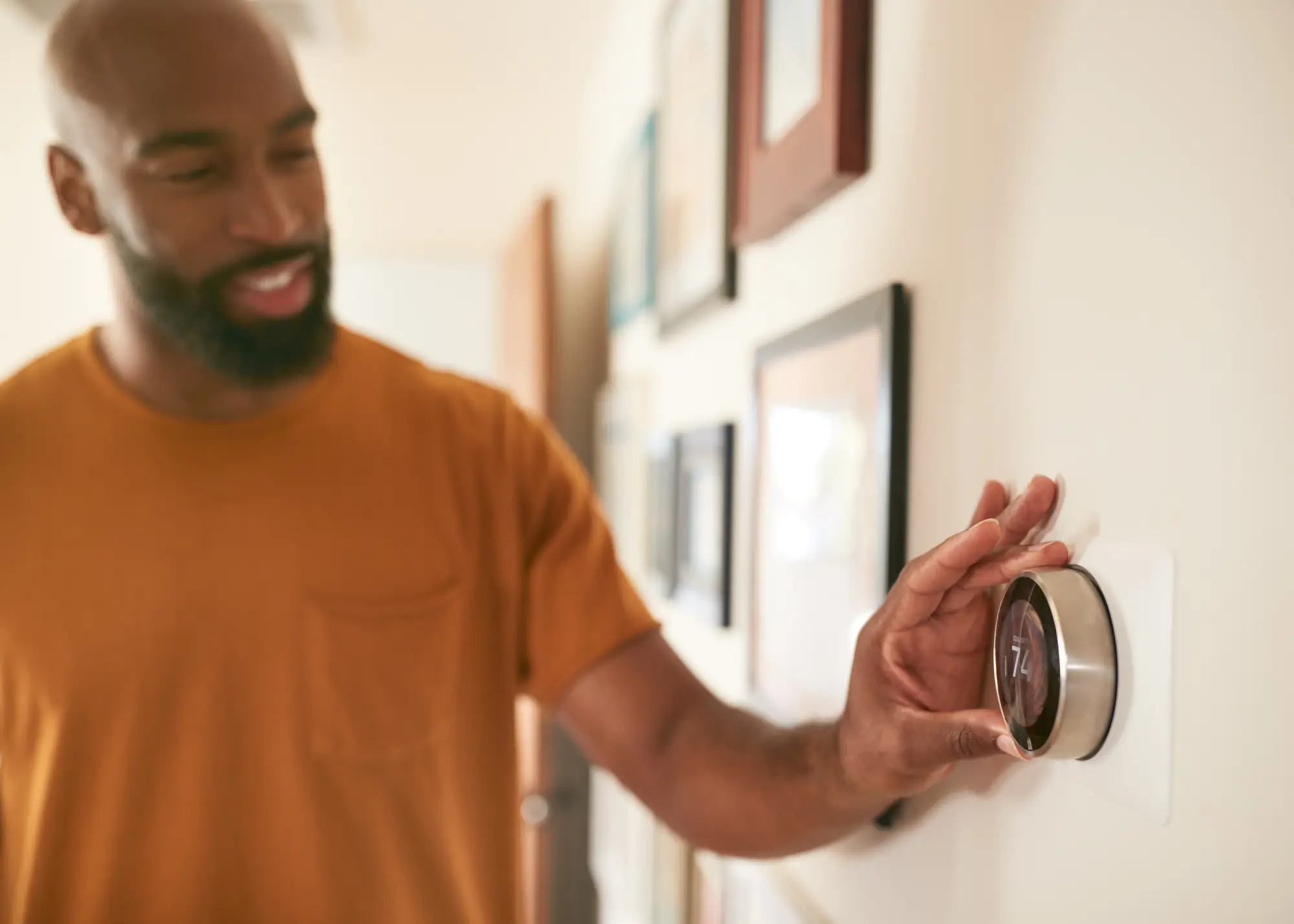 guy touching thermostat