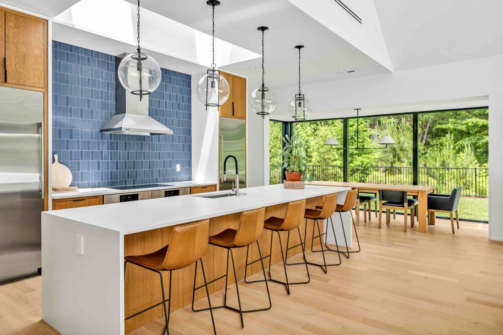 kitchen with island and chairs, blue backsplash