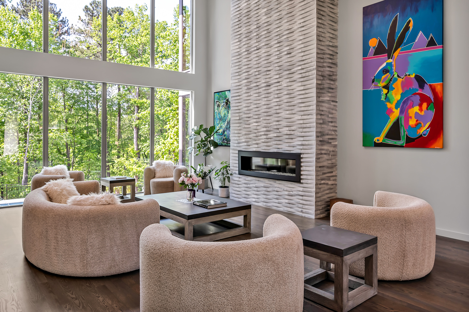 living room with stone firplace and colorful painting of a rabbit