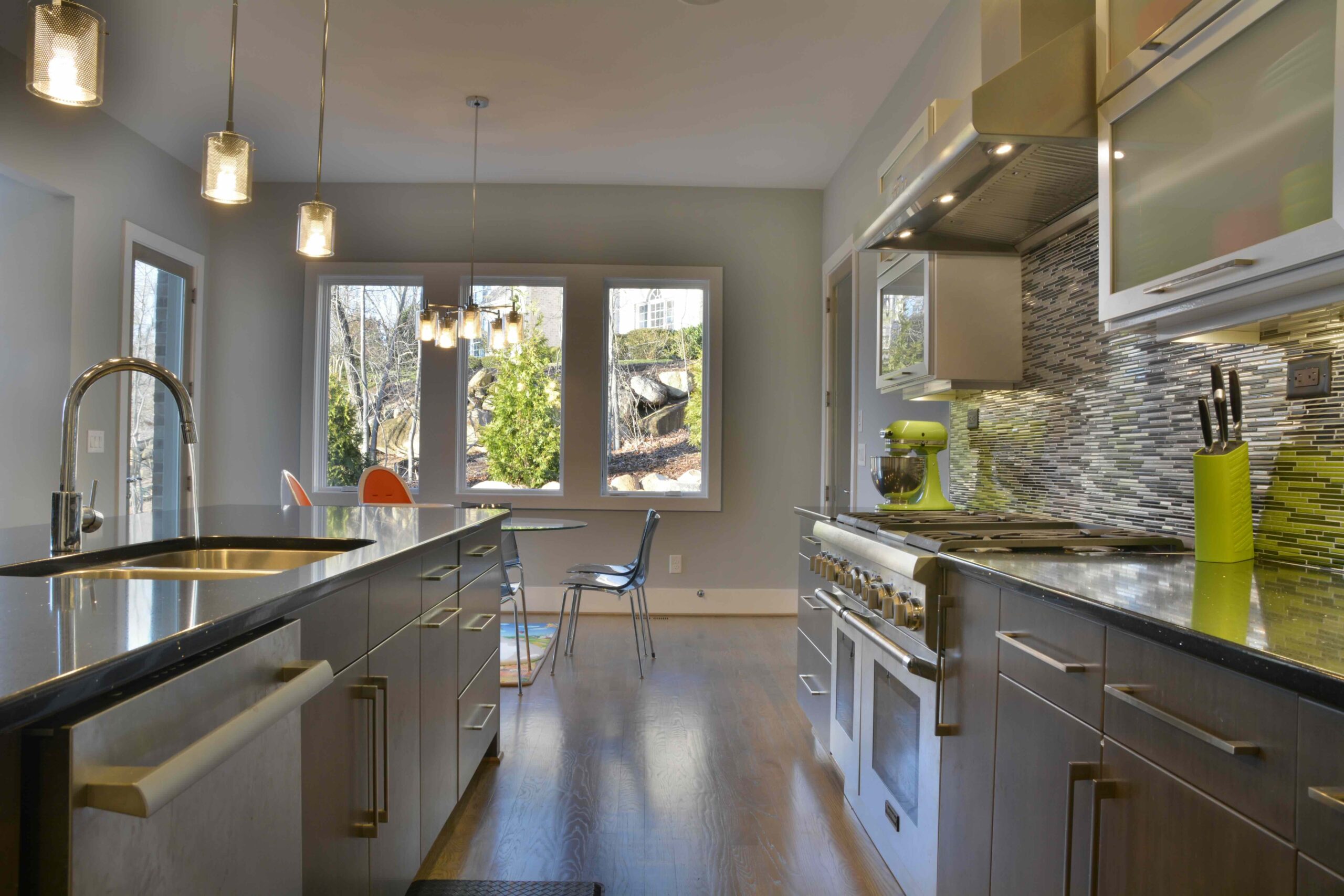 Modern kitchen with stainless steel appliances and green accents