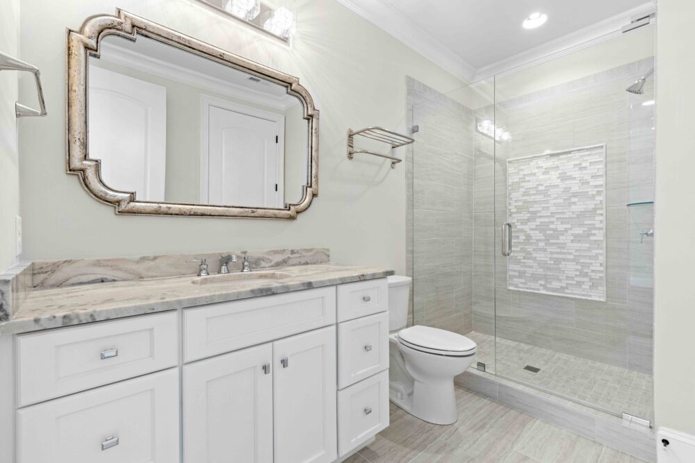 bathroom with vanity, mirror and shower