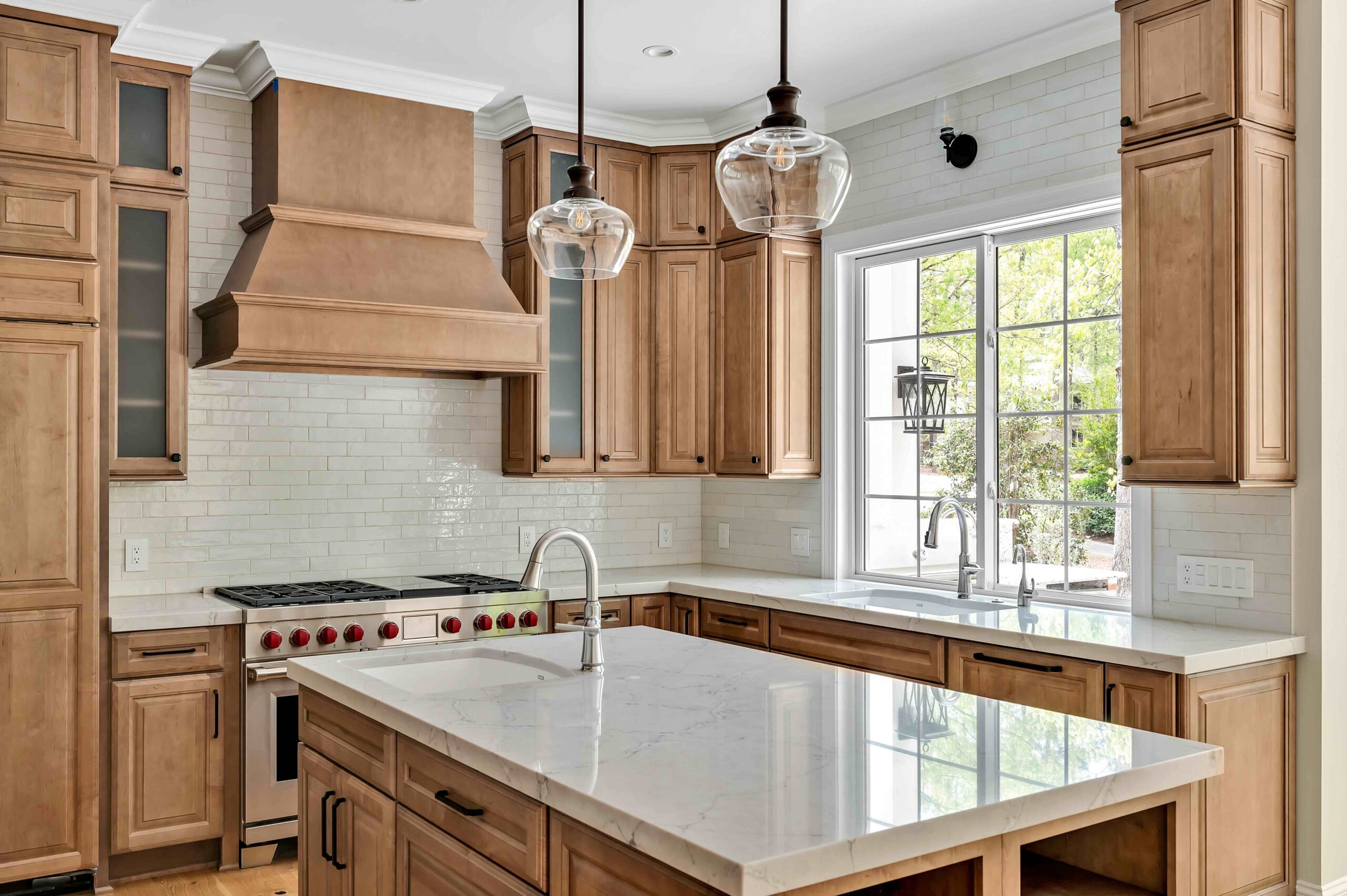kitchen with island, lighting, gas stove and vent hood