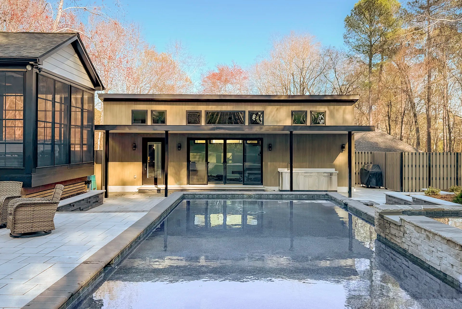 exterior of poolhouse with pool in front