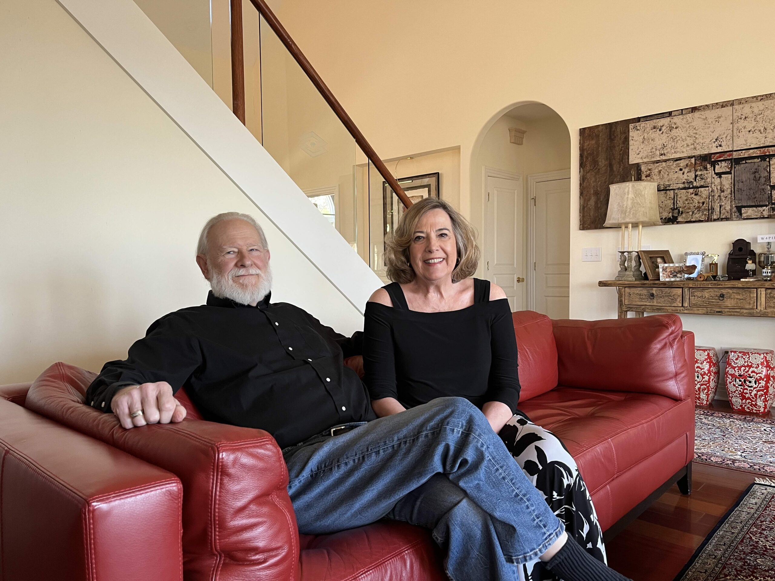 couple poses on red couch