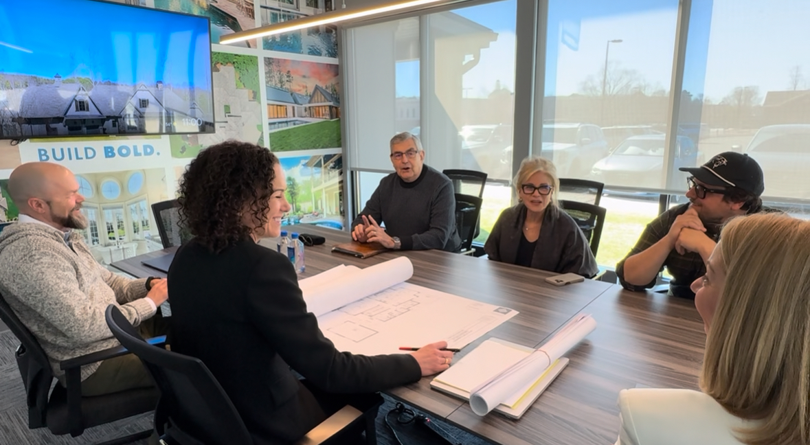people sitting around table at meeting